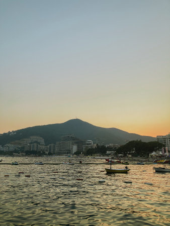 Evening tourist view of the Adriatic sea with mountains and the city of Budva in Montenegroの写真素材