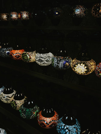 vintage multi-colored lamps with patterns on shelves for sale in store in the ancient city of Kotorの写真素材