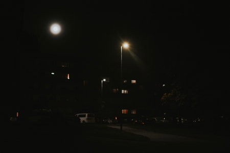 dark walking path in the park with street lighting in form of lanterns with lights on Halloween dayの写真素材