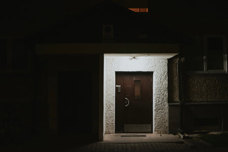 a lantern-lit entrance to a residential apartment building at nightの写真素材
