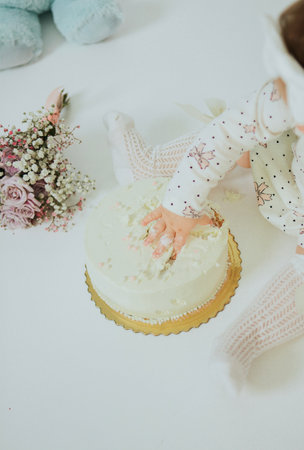Cake smash for a childs first birthday on a white backgroundの写真素材