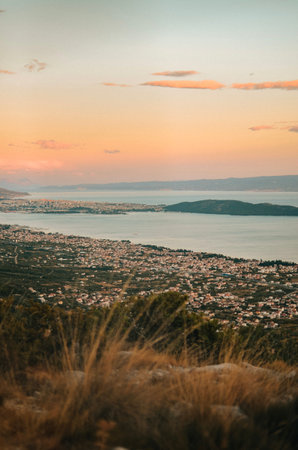 view from the top of a mountain on the Adriatic Sea and a large number of houses at sunsetの写真素材