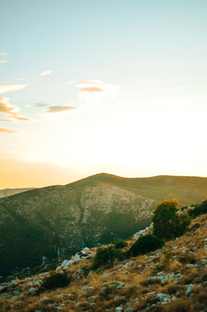 View from the top of the mountain with forest at a beautiful bright sunsetの写真素材