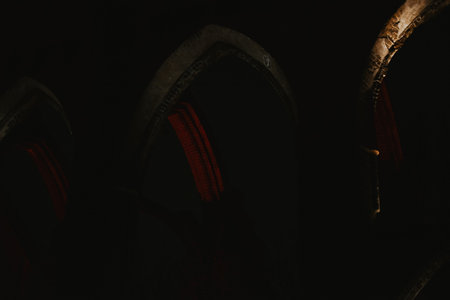 Pointed arch of an old historic brick church with red lighting at night in Europe in a parkの写真素材