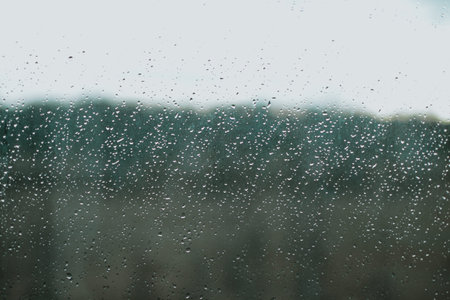 raindrops on the window during a strong hurricane with wind in nature