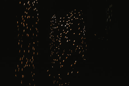 light projection of circles on a brick wall and road in the dark on the street in a chaotic mannerの写真素材