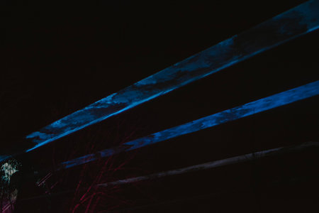 Laser show in the sky in the dark using a color spotlight during a concert close-up. High quality photoの写真素材