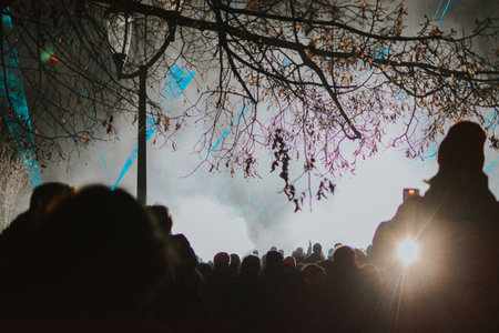 Street concert of a musician in the evening on stage with multi-colored spotlights and a large audience. High quality photoの写真素材