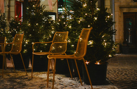 yellow outdoor chairs against a background of Christmas trees at a Christmas market in the city center. High quality photoの写真素材