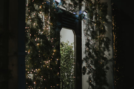 Entrance to a store decorated with fir trees and garlands at the Christmas market in the city center. High quality photoの写真素材
