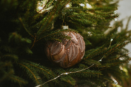 Decorated christmas live tree with garland and golden christmas ball for holidays and gifts. High quality photoの写真素材