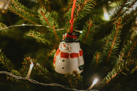 Decorated christmas live tree with garland and christmas ball of snowman for holidays and gifts. High quality photoの写真素材