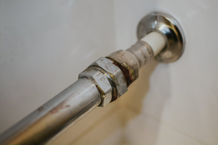 Rust on a metal pipe in a bathroom close-up