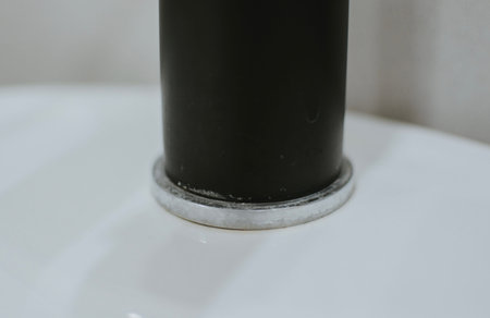 Rusty and coated black faucet in the bathroom close-up. Plaque and rust due to dirty water. High...