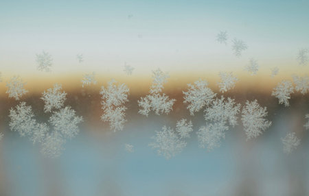 Snowflake pattern on window close-up in frosty winter early morning at dawn. High quality photo