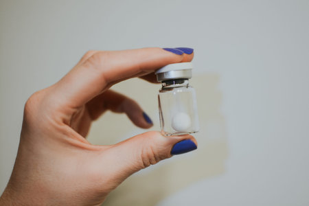 Active collagen, slit ball for skin elasticity in ampoule. Woman holds the product in her hands...