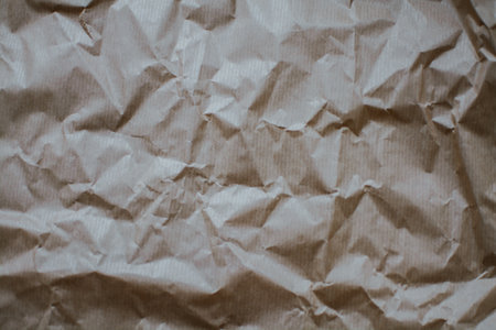 Crumpled eco paper with creases close-up. Textured abstract photo with copy space for text. High quality photoの写真素材