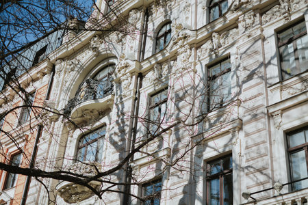 An elegant historic building with a white neo-Renaissance facade. Rich architectural decoration, arched windows, graceful columns and a balcony. High quality photoの写真素材
