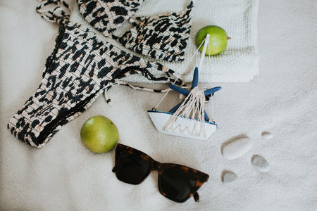 Leopard swimsuit, towel, slippers, glasses and other things for a seaside vacation. Packing a suitcase for a long-awaited vacation. High quality photoの写真素材