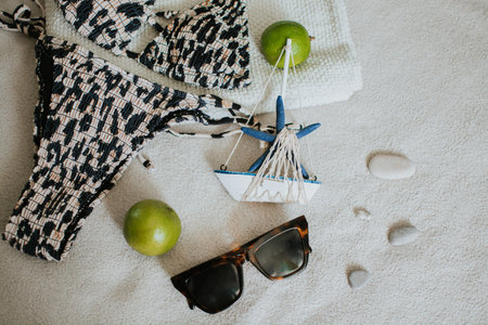 Leopard swimsuit, towel, slippers, glasses and other things for a seaside vacation. Packing a suitcase for a long-awaited vacation. High quality photoの写真素材