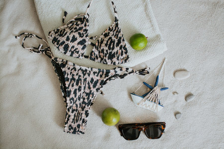 Leopard swimsuit, towel, slippers, glasses and other things for a seaside vacation. Packing a suitcase for a long-awaited vacation. High quality photoの写真素材