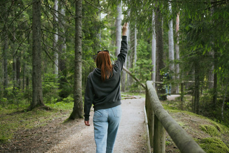 Red hair woman walking in nature in the forest for health. Travel to another country for hiking....