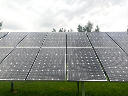 Solar panels outdoors with trees in the background, a blend of technology and nature. High quality...