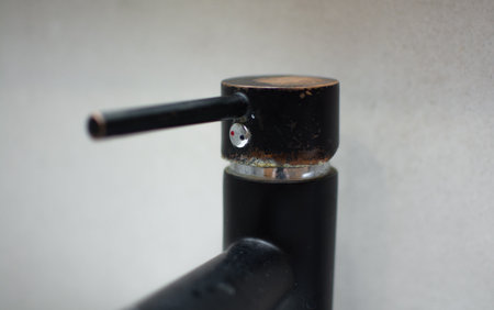 Rusty black faucet in the kitchen close-up. Plaque and rust due to dirty waterの写真素材