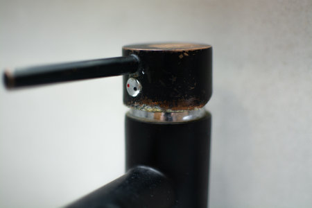 Rusty black faucet in the kitchen close-up. Plaque and rust due to dirty waterの写真素材
