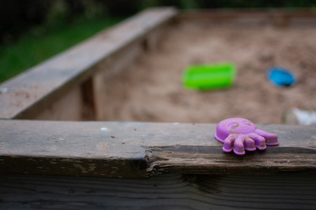 Purple jellyfish mold for sandbox lying on a sandbox outdoors.の写真素材