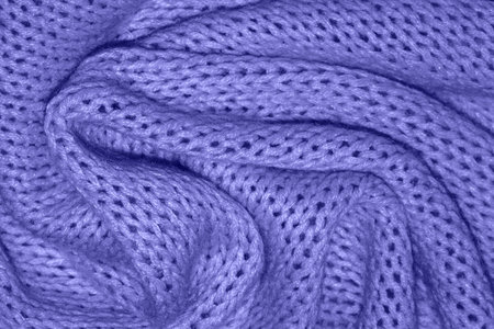 Very beautiful Texture of a warm knitted purple sweater with folds. Pigtails pattern, soft focus....