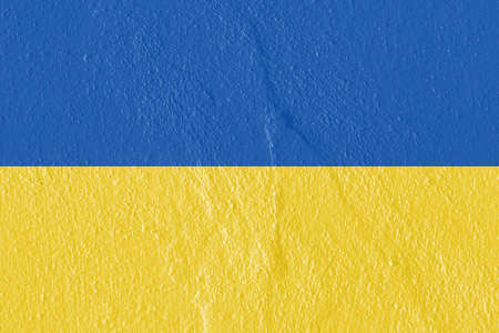 National Yellow and Blue Flag of Ukraine painted on beautiful textured concrete wall. The art of rough stylized texture. Copy space.の写真素材
