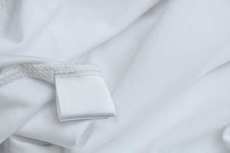Blank label for composition and description of fabric on a background of white clothing texture. Wardrobe care.の写真素材