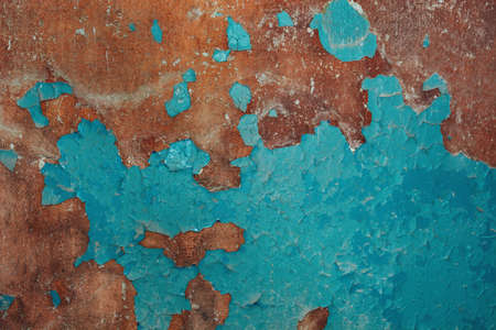 Brown-blue color of peeling cracked paint on the old wall. For texture or background, pattern. soft selective focusの写真素材