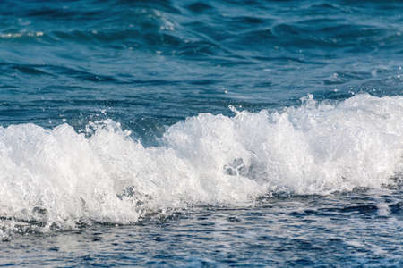 Beautiful sea wave with splashes of blue water and foam. Copy space business travel and leisure concept.の写真素材