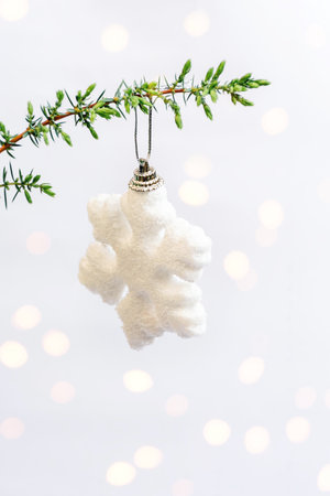Christmas decorations in open gift box and golden round sparkles bokhe. Green sprig of Christmas tree on red background. Packaging cover with lush bow. Merry Christmas and Happy New Year. copyspace.の写真素材