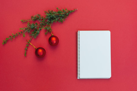 Top view of round Christmas decorations in open gift box on red background. Beautiful red and white round toys. Concept of Christmas and New Year. copyspace. soft selective focusの写真素材