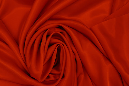 Abstract silk red background. Luxurious smooth elegant wavy fabric. Can be used as Valentine's Day background or other design. Top View, Copy Spaceの写真素材