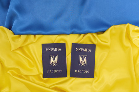 Passports of citizens of Ukraine on blue and yellow background of the Ukrainian Flag. Support of country during occupation.の写真素材