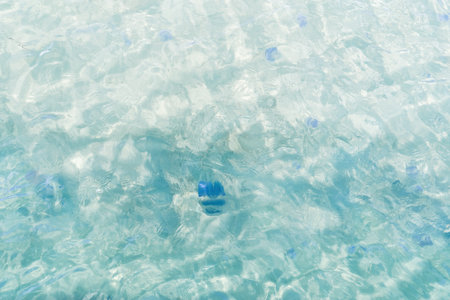 Surface of transparent blue clear sea water with lot of jellyfish. Danger to recreation. Sunlight passes through water, creating light and shadow. soft selective focusの写真素材