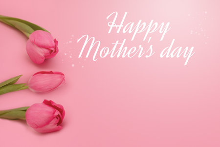 Happy Mother's day lettering and gentle tulips on pink background. greeting card concept. copy spaceの写真素材