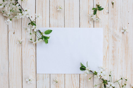 Cherry flowers and a white sheet of paper.