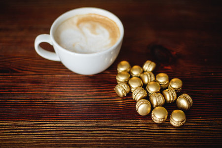 Cappuccino and golden macaroons.の写真素材