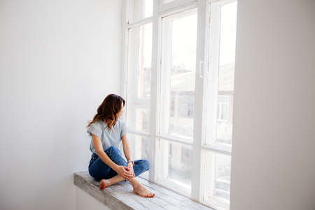 Beautiful girl by the window.の写真素材