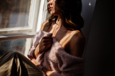 Beautiful girl by the window.