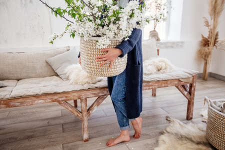 Basket with flowers in hands.の写真素材