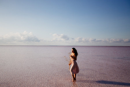Beautiful girl on a pink lake.
