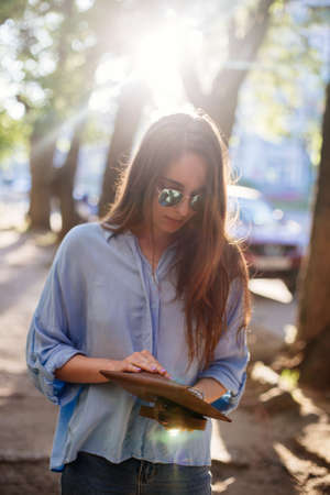 Girl is holding a clutch bag.の写真素材