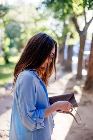 Girl is holding a clutch bag.の写真素材