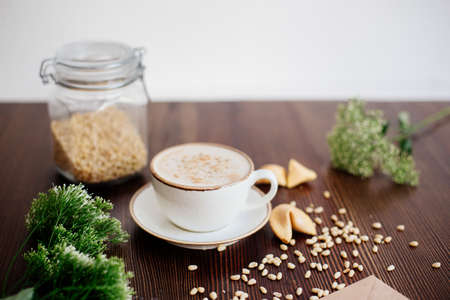 Cappuccino with nuts on the table.の写真素材